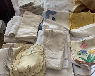 Lots of table linens-- tablecloths, napkins, table runners, and placemats