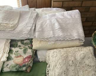 Lots of table linens-- tablecloths, napkins, table runners, and placemats