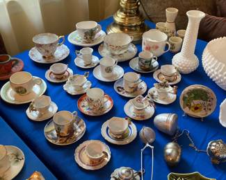 Large selection of souvenir tea cups from around the US