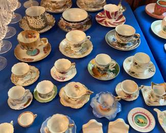 Large selection of souvenir tea cups from around the US