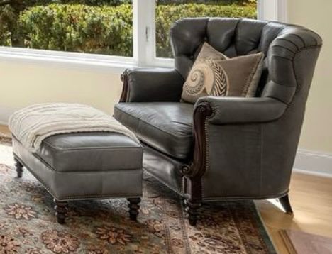 Pair of beautiful slate custom leather chairs with one matching ottoman.