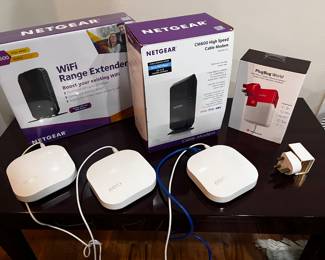 Eero wi-fi extenders, Netgear, and international plug adapter.