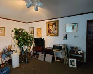 TV, queen ann table, wall hangings, vacuums, microwave, small table, folding chairs, iron and ironing board, tv tray
