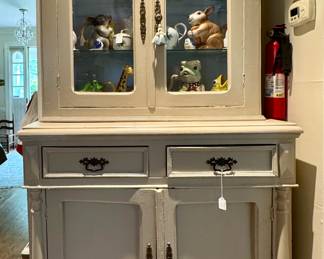 Antique cupboard - filled with cookbooks and a super fun collection of antique and animal pitchers