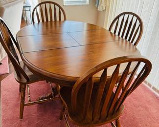 Kitchen table with 6 chairs. Leaf folds down inside the table