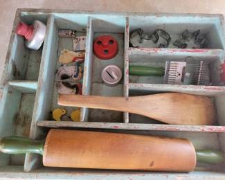 Old green painted kitchen drawer with vintage baking items