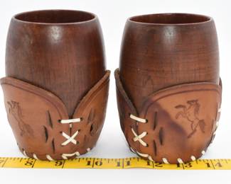 pair of wooden cups with leather wrap