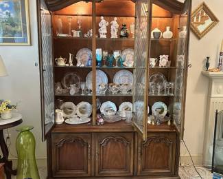 D46 - $150. Lighted China Display Cabinet. Assembled it is 80.5" tall. Base Measures 57" wide x 16" deep x 25" tall. Top Measures 54" wide x 14" deep x 55.5" tall.
