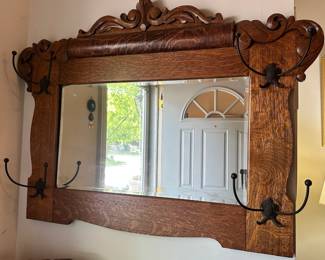 D24 - $175. Antique Oak Framed Mirror with Hooks. Measures 37" wide x 31.5" tall. Excellent Condition!