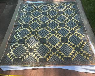 D62 - $85. Hand Pieced Quilt in Good Vintage Condition. See Tape Measure on ground for an idea of size. See next photo for back of quilt fabric.