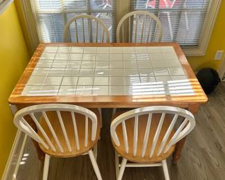 D16 - $100. Tile Top Table with 4 Chairs. Measures 48" x 31" x 29" tall.