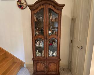 D31 - $75. Lighted Curio Cabinet measures 26" wide x 12.5" deep x 73.5" tall.