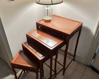 D29 - $225. Set of 4 Carved Nesting Tables. (I believe they are Rosewood) Largest Measures 19" x 14" x 28" tall. Top 3 have glass on top.