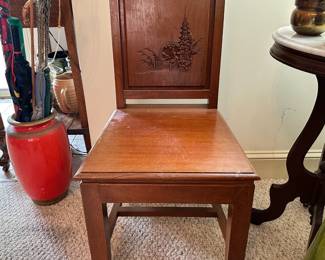 D26 - $30. Carved Wooden Chair. Back Corner is chipped. Otherwise in good condition. Measures 17" floor to seat. 35" tall.