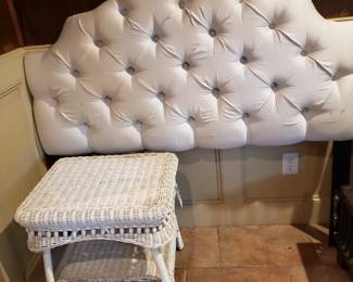 WHITE UPHOLSTERED HEADBOARD AND WICKER TABLE
