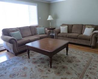 Pair of neutral sofas, side table, coffee table with storage drawer, area rug