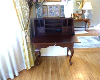 Drop front desk, silk flowers, framed pictures