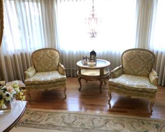 Pair of bergere chairs, round curio side table