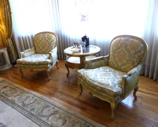 Pair of bergere chairs, round curio side table