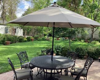 Handsome patio table & 6 chairs Umbrella with stand included.