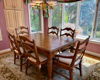Table with 6 broom bottom chairs .