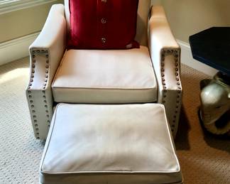 White upholstered armchair with matching ottoman