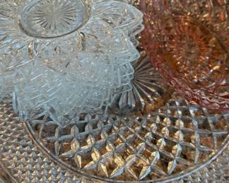 Cut glass plates and pink depression glass bowl