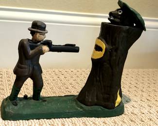 Cast iron hunter and bear in tree bank