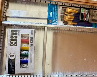 Paints and brushes inside drawer
