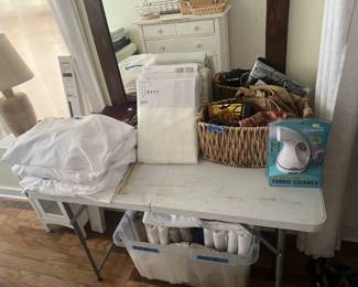 sheets, curtains, steamer, towels, t-shirts, dresser, baskets, giant antique mirror