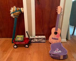 Barbie guitar, Hess helicopter, stick horse, red Ryder, doll wagon, box of Crayola crayons