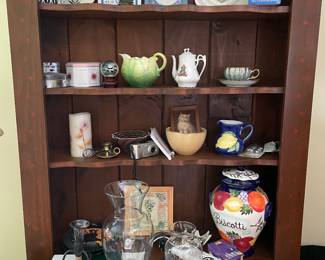 Wooden hutch, with vases, pictures, trivets, and cookie jar