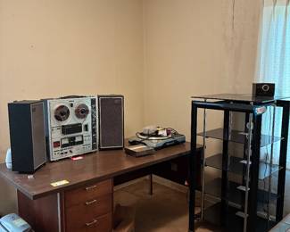 Vintage reel to reel, desk, stereo shelf.