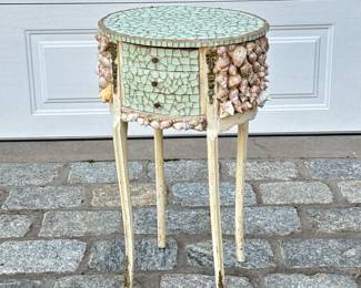 SEASHELL & GLASS MOSAIC SIDE TABLE | A whimsically decorated oval side table with inlaid glass mosaic and seashells having 3 drawers - h. 28 x w. 16.5 x d. 13 in