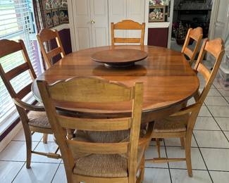 Ethan Allen Pedestal Dining Table with 2 leaves and a lazy susan. The six chairs are Drexel with rush seats.