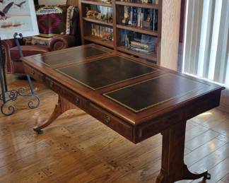 John Widdicomb leather topped desk with brass caster feet. Custom glass top (not pictured).
