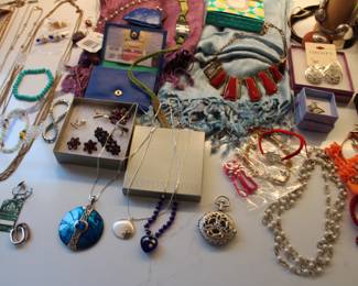 large collection of costume jewelry along with various sterling silver pieces.