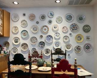 Wall of Texas souvenir plates, great Mexican chairs and French farmhouse antique table