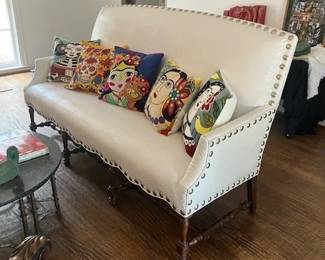 Faux reptile white sofa, needlepoint throw pillows.