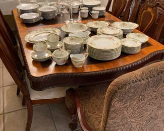 ornate dining table and six chairs, three sets of china