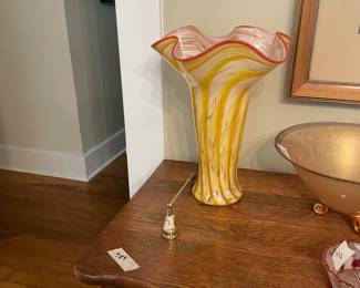 Large yellow and gold swirled vase hand blown by One Eared Cow Gallery in Columbia.