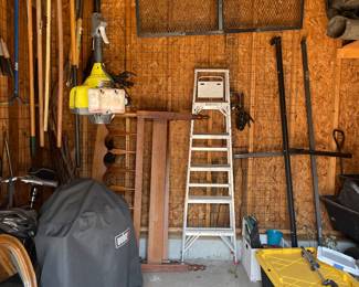 Shed full of tools, shelving, wheelbarrow lawnmower 