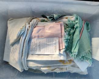 Bin full of Hand crocheted tablecloths, table runners, napkins and towels