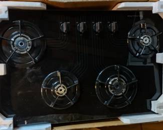 Glass gas stove top almost new in box. Was in a model home and the buyer didn't like it being black and she had the same model in white put in... Just like new :)