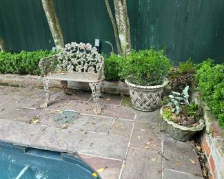 Very old iron settee , many great planters with blooming flowers