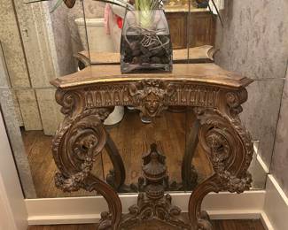 French carved console with a face and urn detail