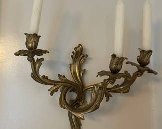 One of four bronze candlestick sconces