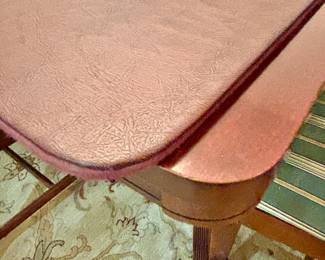 Dining room table has protective pad.