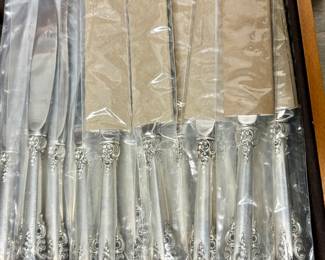 112-Piece Wallace Grand Baroque Sterling Silver - 12 Place Setting with Serving Pieces and wooden Pacific Silvercloth storage chest. MOST PIECES STILL IN ORIGINAL WALLACE PLASTIC PACKS -NEVER OPENED OR USED.