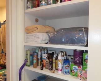 Shelves of personal hygiene items, towels, bed linens, cleaning supplies.